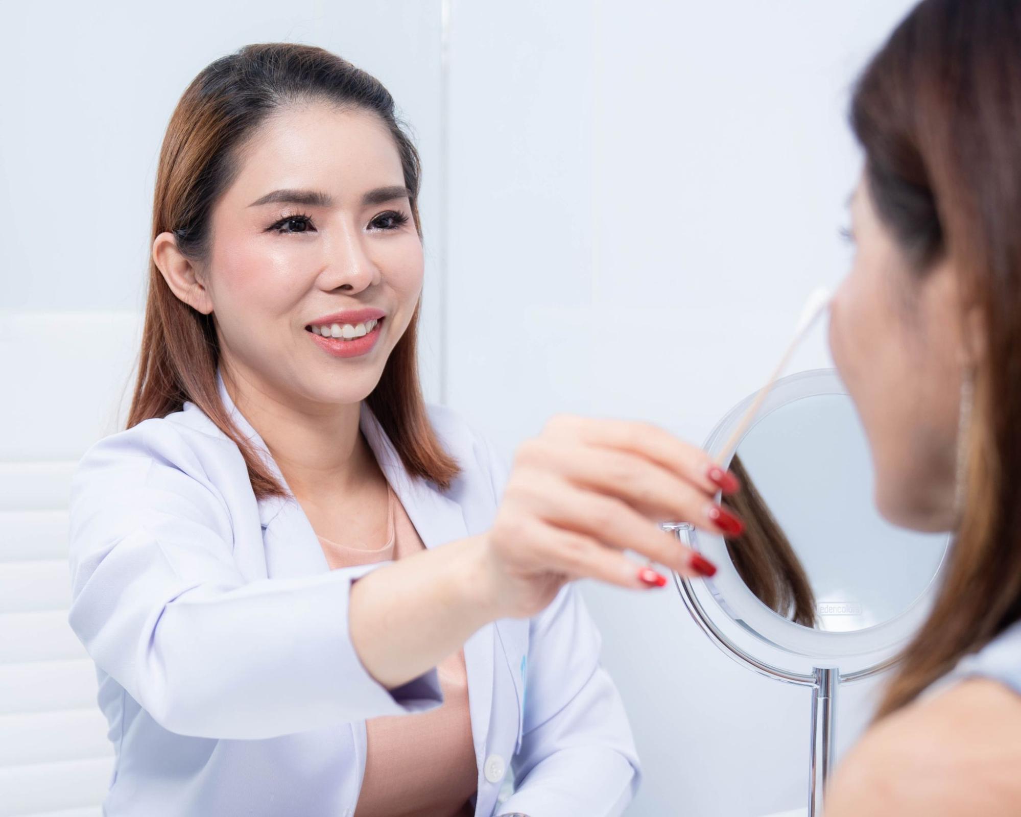 Doctor assessing facial concerns by Dr.Varunee Potinamtong