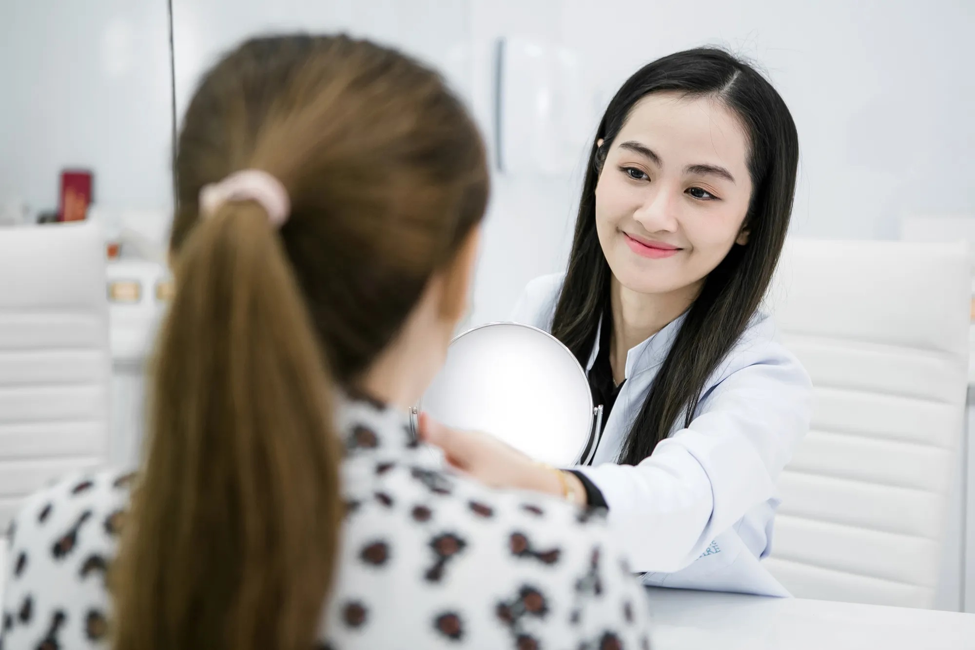 Doctor assessing facial structure by Dr.Kornkanok Kantha