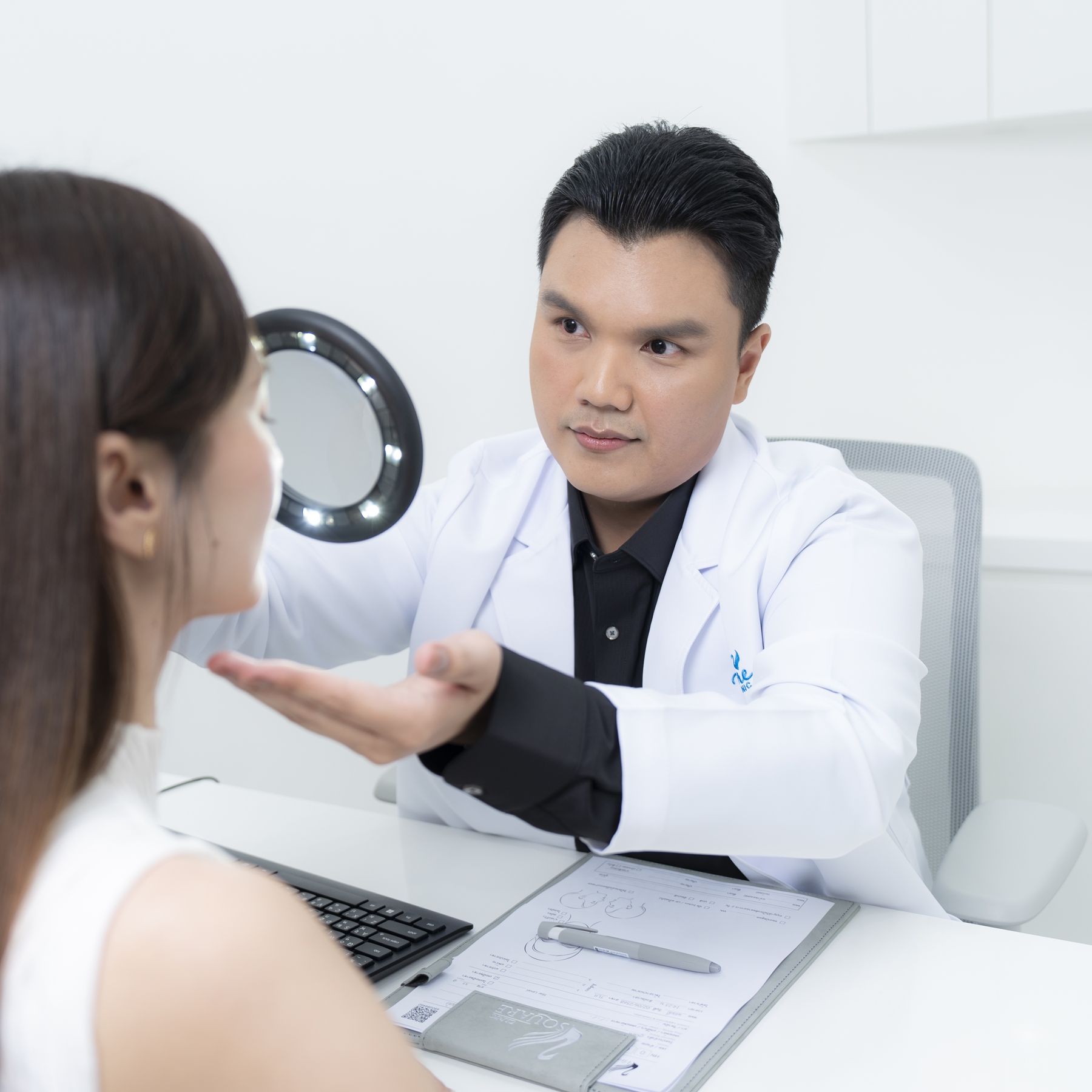 Doctor assessing the face by Dr.Suranart Deesuwan