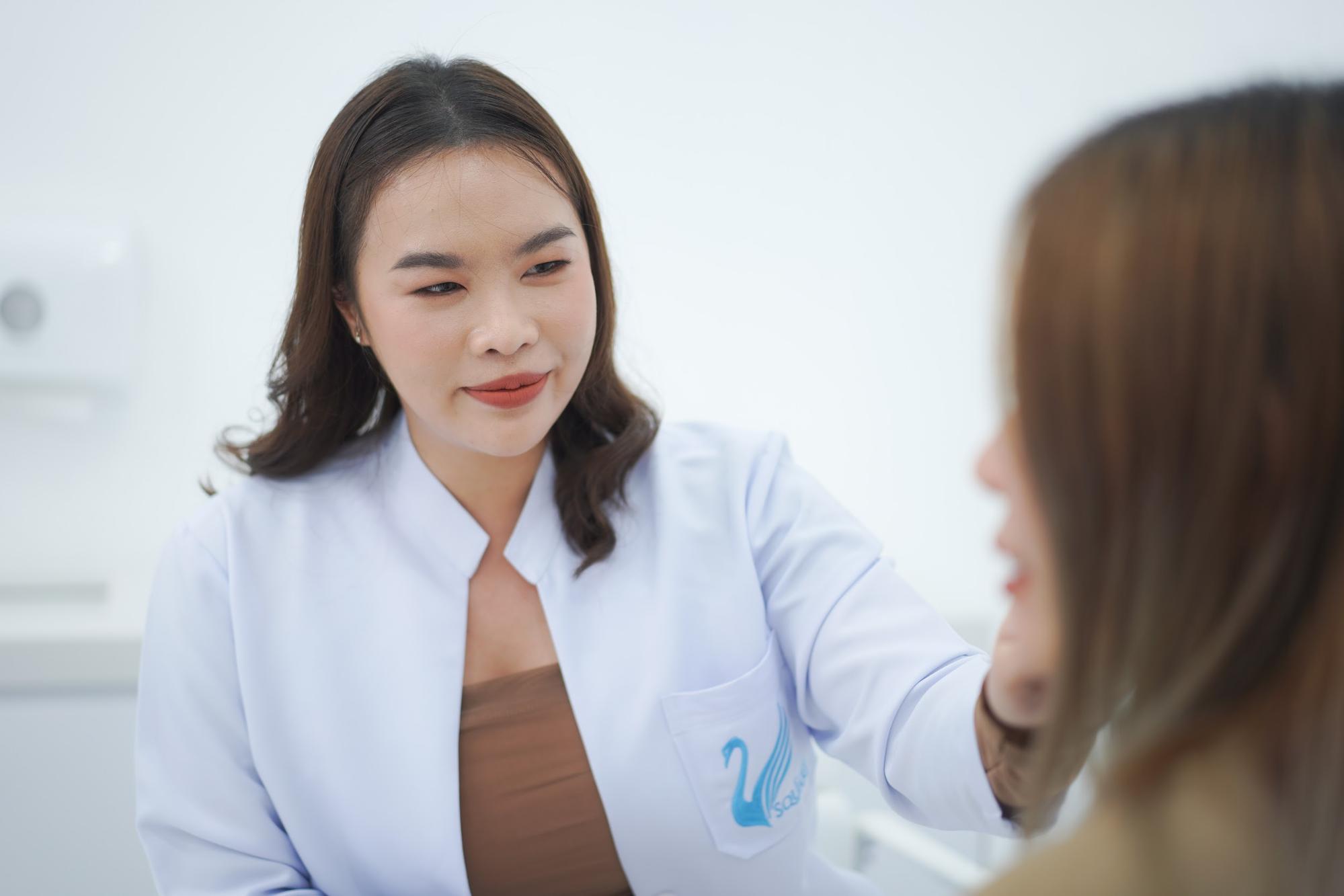 Doctor evaluating patient’s face by Dr.Narumol Jitnarong