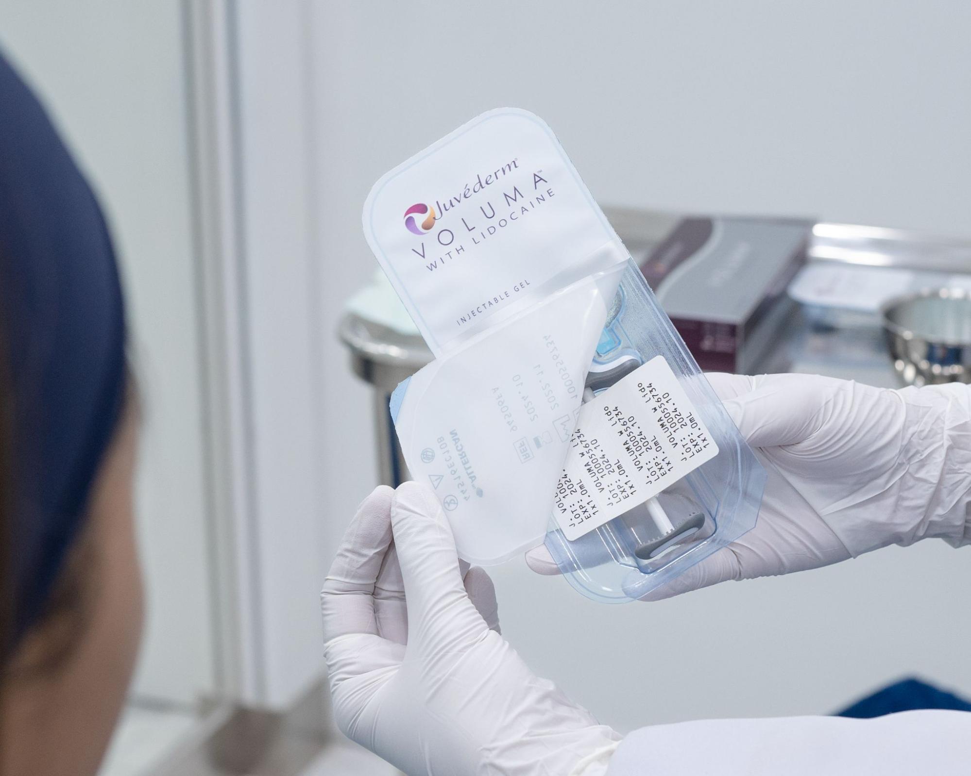 Doctor opening the filler box in front of the patient